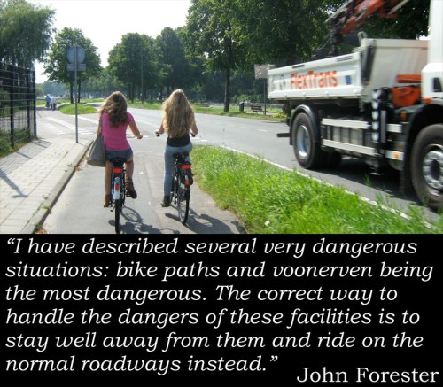 Photo of two girls cycling safely on cycle path away from the busy road, with John Forester quote: "I have described several very dangerous situations: bike paths and voonerven being the most dangerous. The correct way to handle the dangers of these facilities is to stay well away from them and ride on the normal roadways instead."