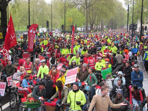 London Cycling Campaign's 2012 rally, called the Big Ride. Thousands of people on bikes are attending, but very many are wearing helmets, high-visibility clothing, and lycra.