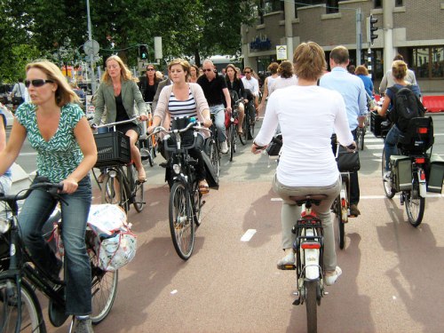 Rush hour in central Utrecht, Netherlands. Many people of all ages riding bikes in their normal clothes, without the safety equipment deemed necessary in the UK.