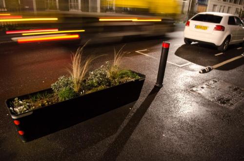 Royal College Street in Camden, showing a planter, bollard and armadillo to protect the cycle lane.