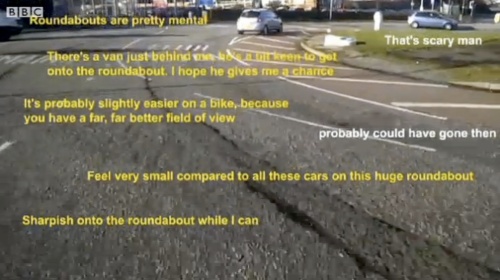 Screenshot from BBC News report, showing footage of cycling journey around a roundabout, superimposed with quotes from those cycling, such as 'Roundabouts are pretty mental'