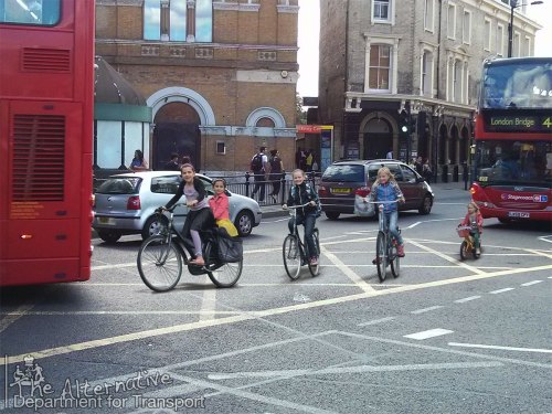 A photo of five young girls cycling in the Netherlands, mixed with the horrible bus-choked reality at Hackney Central