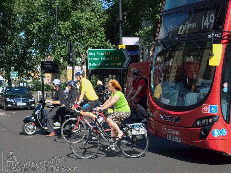 A photo of a late-middle-aged woman riding a bike in the Netherlands has been cut out and pasted into a London traffic scene, scarily close to a bus
