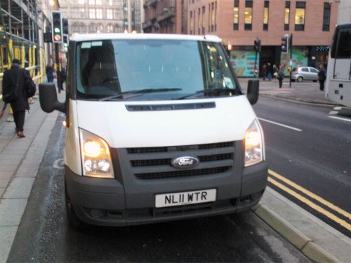 A van parked on a cycleway, blocking it.