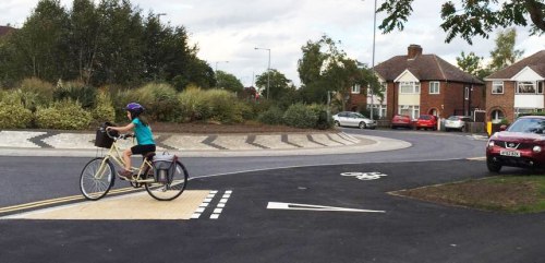 Brand new roundabout in Cambridge, where people on bikes are expected to mix with people walking. The footway has road markings painted on it.