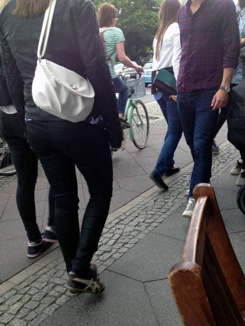 People walking and cycling closely on a cycleway and footway in Berlin, where a pavement café doesn't help matters.