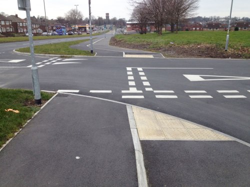 Very poorly designed junction of cycleway, footway and side road, with vague priority and mess of white paint